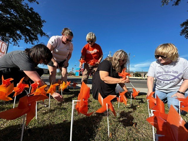 Zonta members placing orange pinwheels